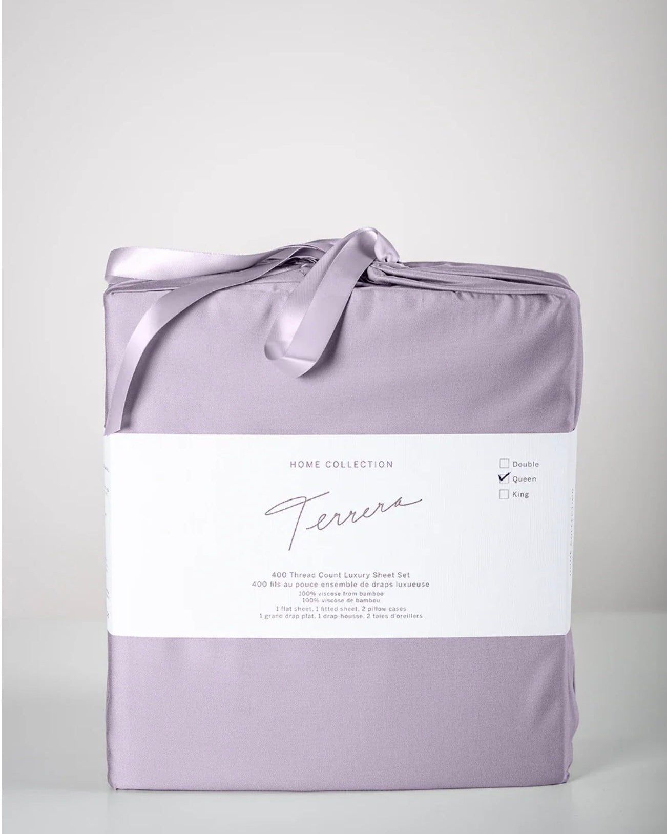 A bamboo sheet set in purple, packaged and tied with a ribbon, with a label showing the brand name.